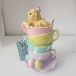 Easter Chick Holding A Flower Sitting in Pastel Stacked Teacups Resin 7 In Decor